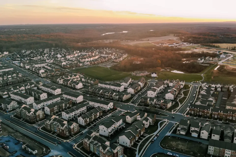 Aerial view of white homes and buildings in Clarksburg, Maryland.